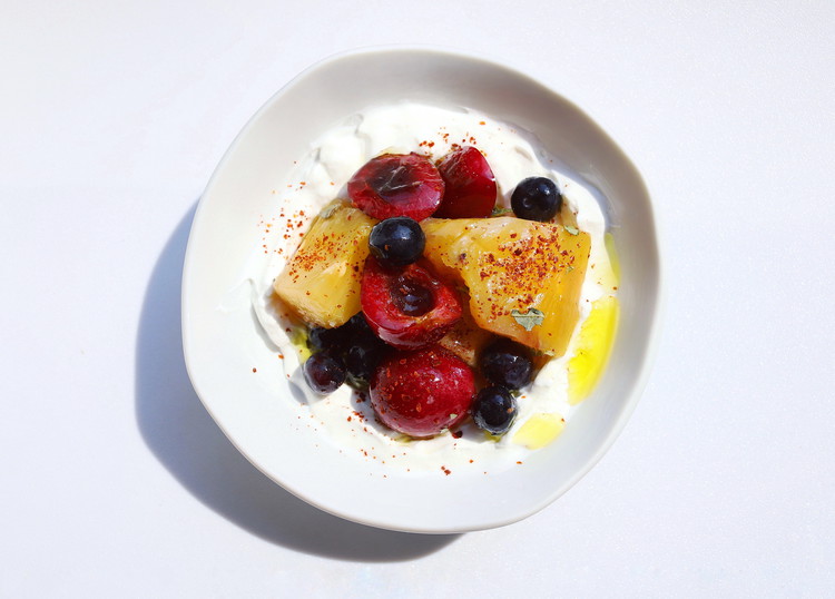Image of For something richer: on a serving plate smear labneh into an even ring that's higher on the outside, forming a well, top with the salad and garnish with olive oil, plus Aleppo pepper to balance the fat.